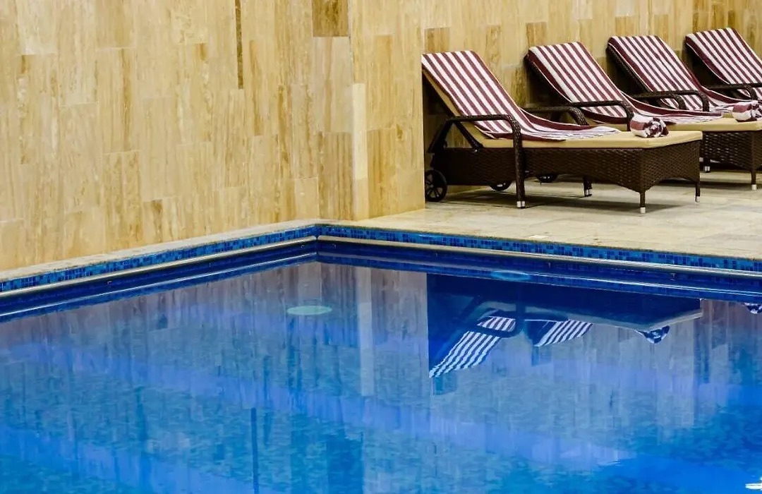 Heated indoor pool with striped loungers