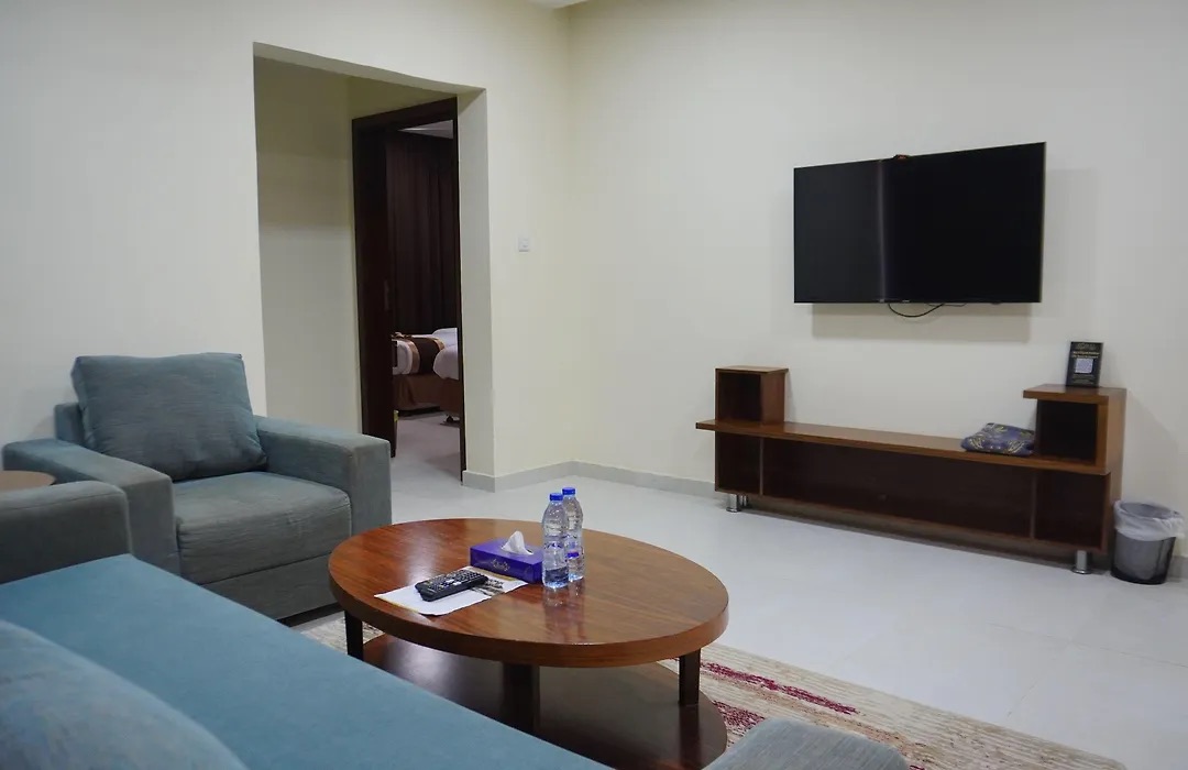 Suite living room with a sofa and wall-mounted TV